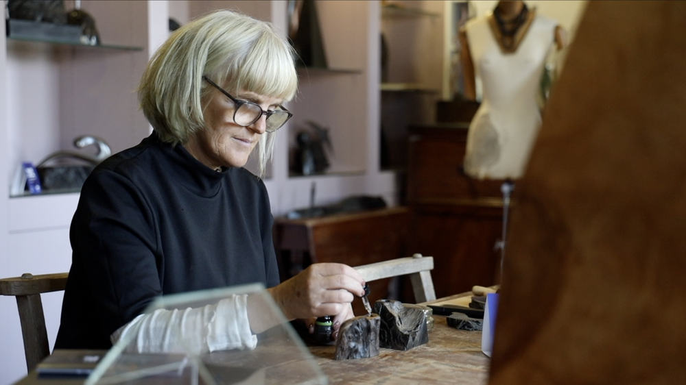 Eibhlín Ní Chongháile of Celtic Roots at her workbench, oiling two pieces of bog oak