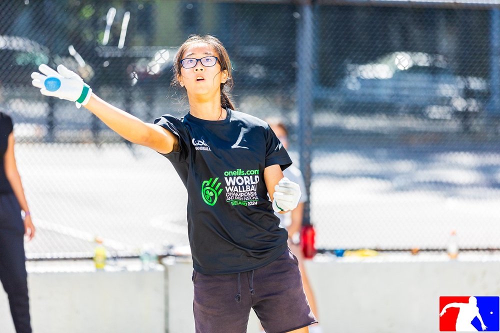 Action shot of Tiffany reaching to hit the ball