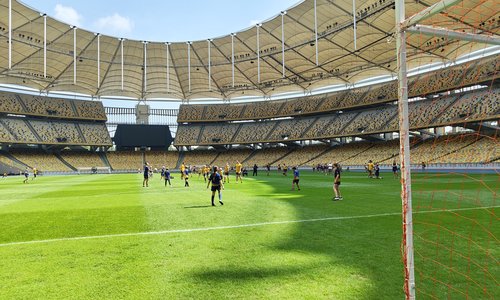 The pitch in the Bukit Jalil National Stadium with GAA players