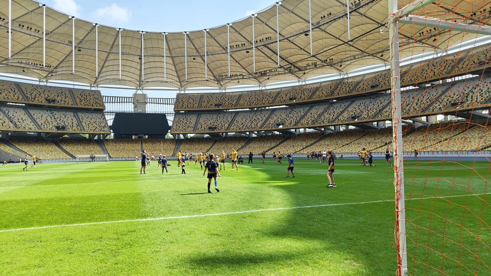 The pitch in the Bukit Jalil National Stadium with GAA players