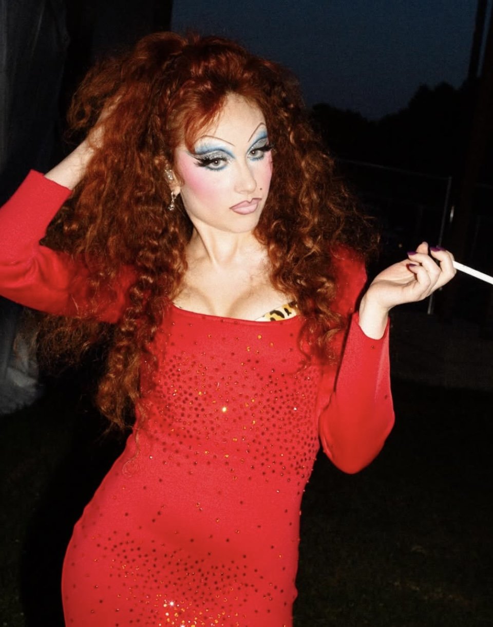 Chappell Roan in a red dress holding a cigarette