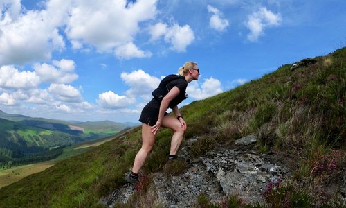 Ivana Kolaric climbing a mountain on a sunny day