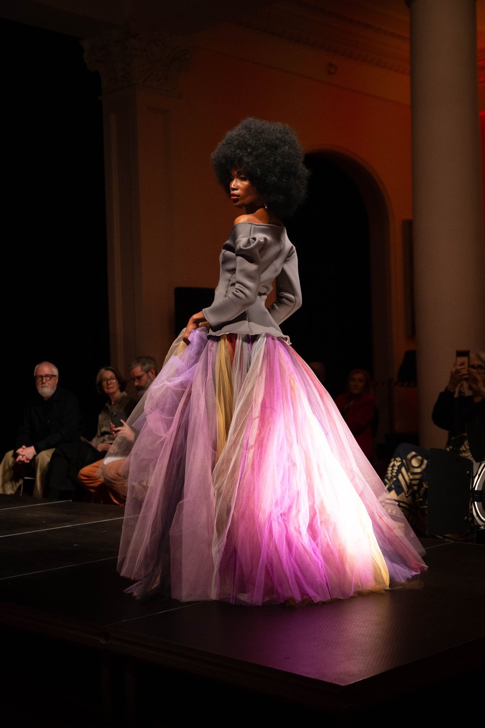 A model on the runway wearing a multicoloured tulle circle skirt