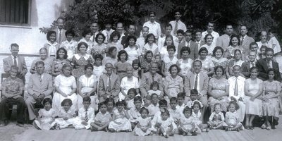 A black and white family photo of 50+ people in formal dress.