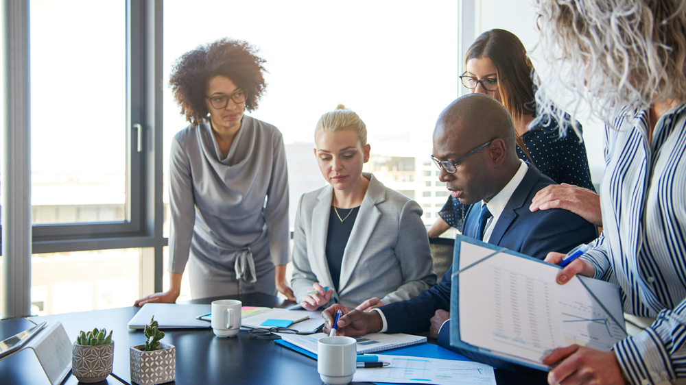 Group of people from different backgrounds working together