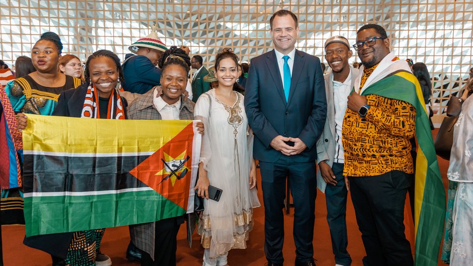 Irish fellows programme participants standing together with flags
