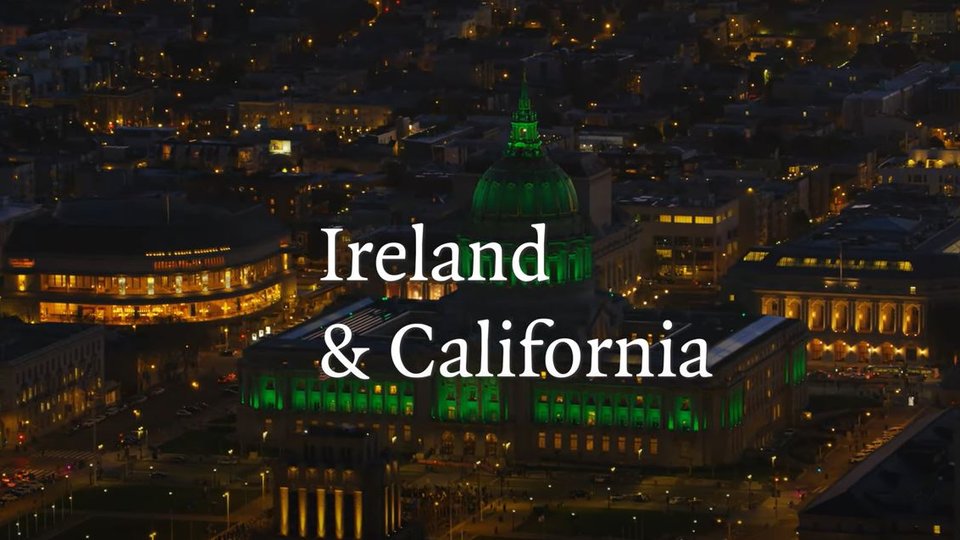 A building lit up in green with a text overlay reading 'Ireland & California'
