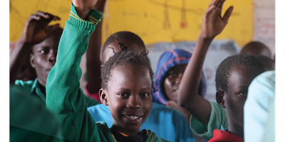 Irish Aid Annual Report 2023 front cover featuring school children in a classroom