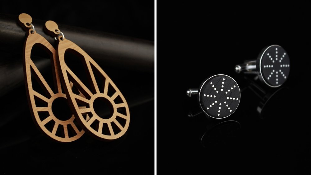 Examples of Rowena Sheen's wooden earrings. Left: lighter, warmer tone drop earrings with a sun motif laser cut into them. Right: Iron oxide treated dark wooden studs with silver inlay in a radial pattern.