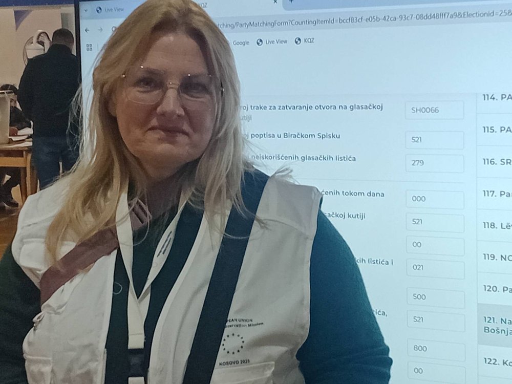 Janet Colgan – in front of a screen watching the Results Coming in