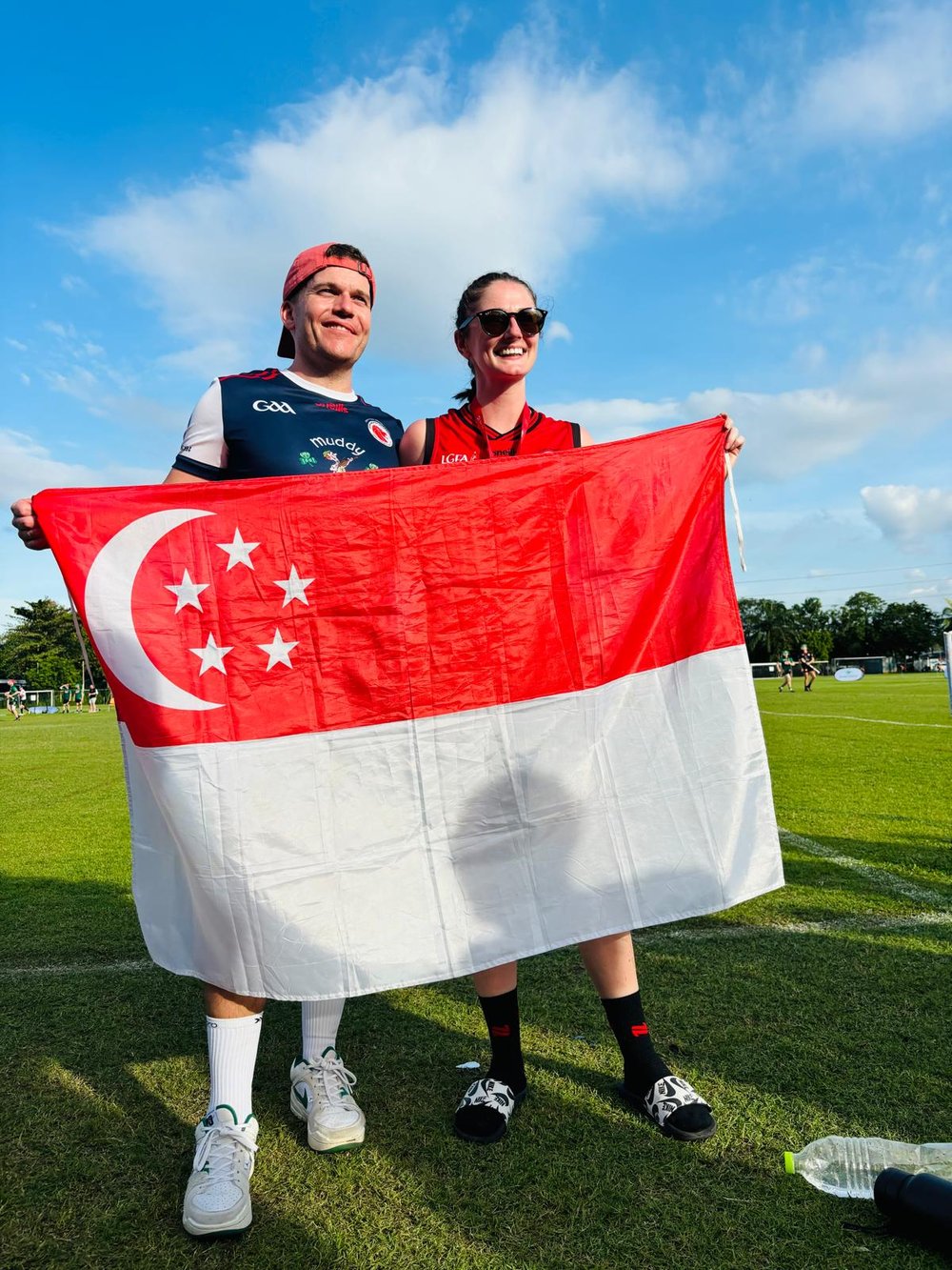Karen and Andy Muligan holding a Singapore flag