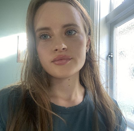a young woman with fair hair taking a selfie