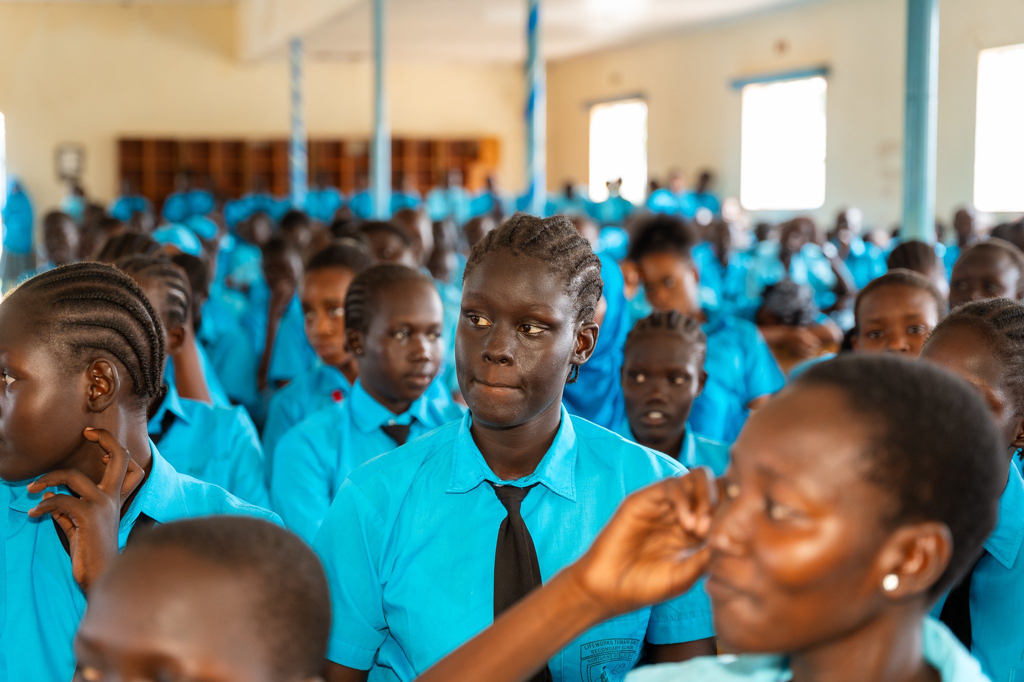 Group of girls in school uniforms taking part in Young Scientist Kenya programme