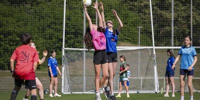 Two GAA players jumping for the ball