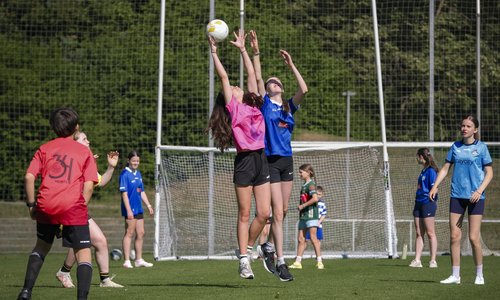 Two GAA players jumping for the ball