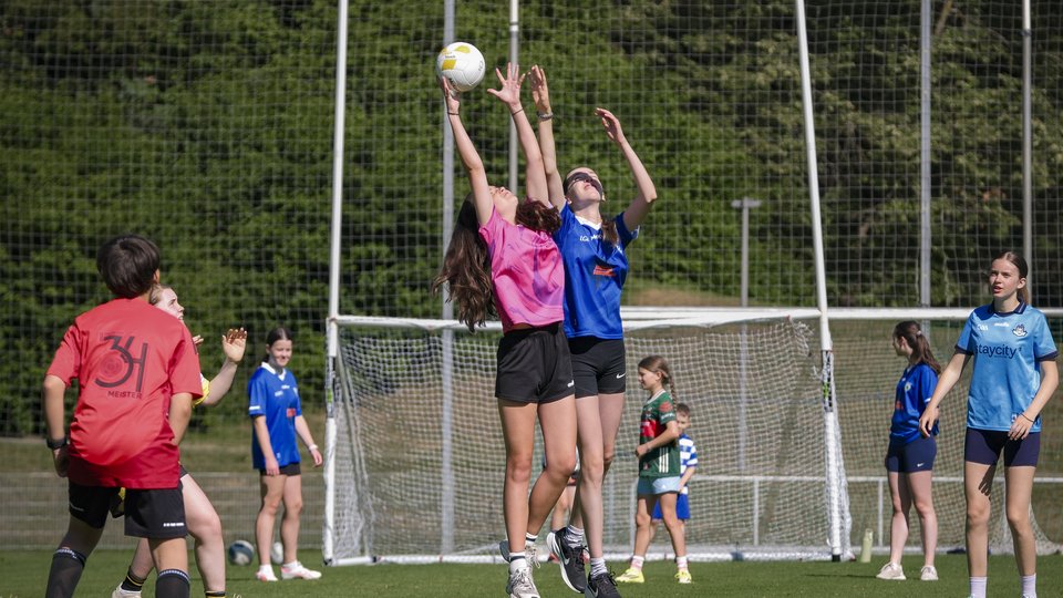 Two GAA players jumping for the ball