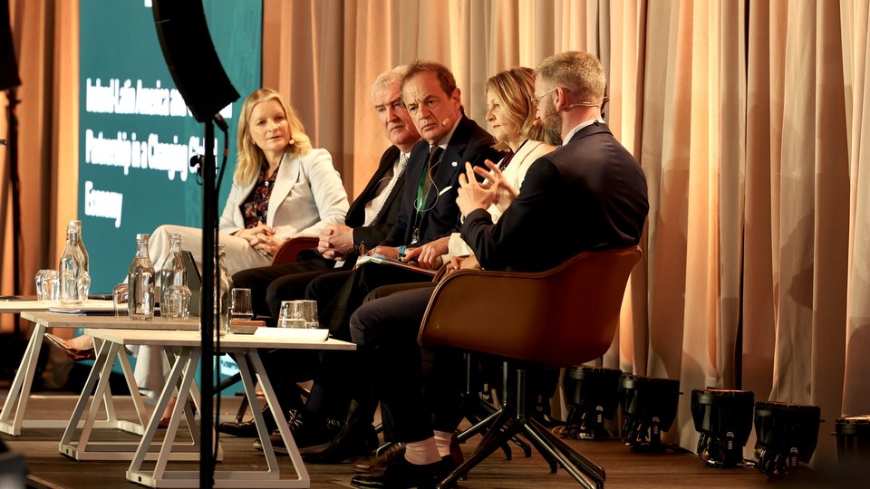 A panel sitting on a stage discussing Latin America and the Caribbean
