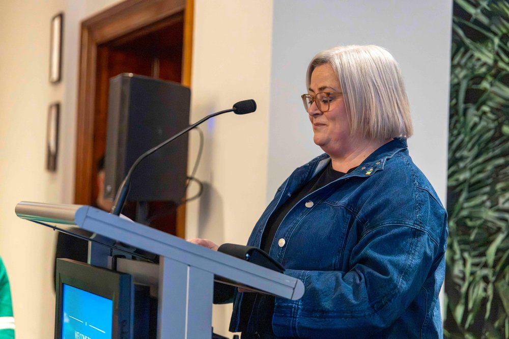 Consul General Lorraine Christian speaking at a podium during a reception in Sydney.