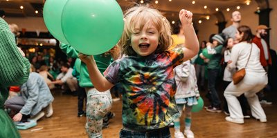 small child with green balloon