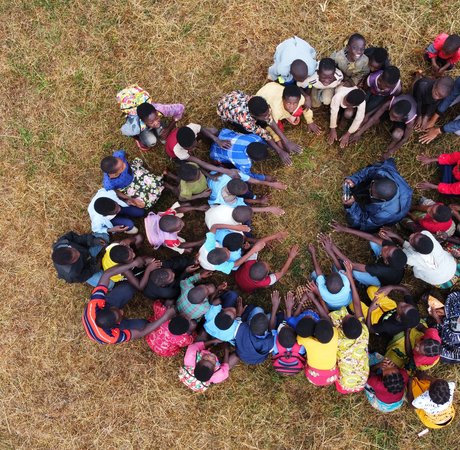 Group of children putting their hands together