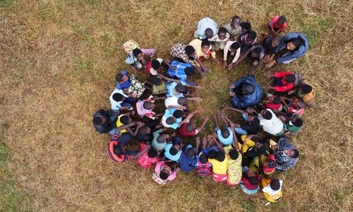 people sitting around in a circle from above