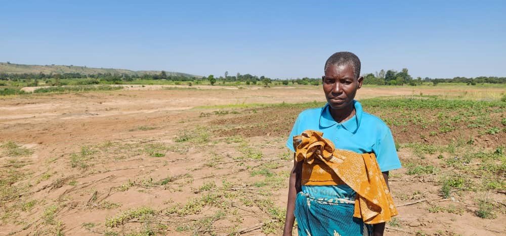 Margret Kanyenda standing in her washed away field