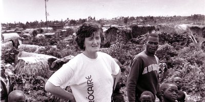Mary Sweeney standing amongst a group of children in Rwanda.