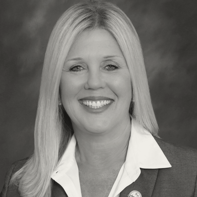 A woman in a suit smiling