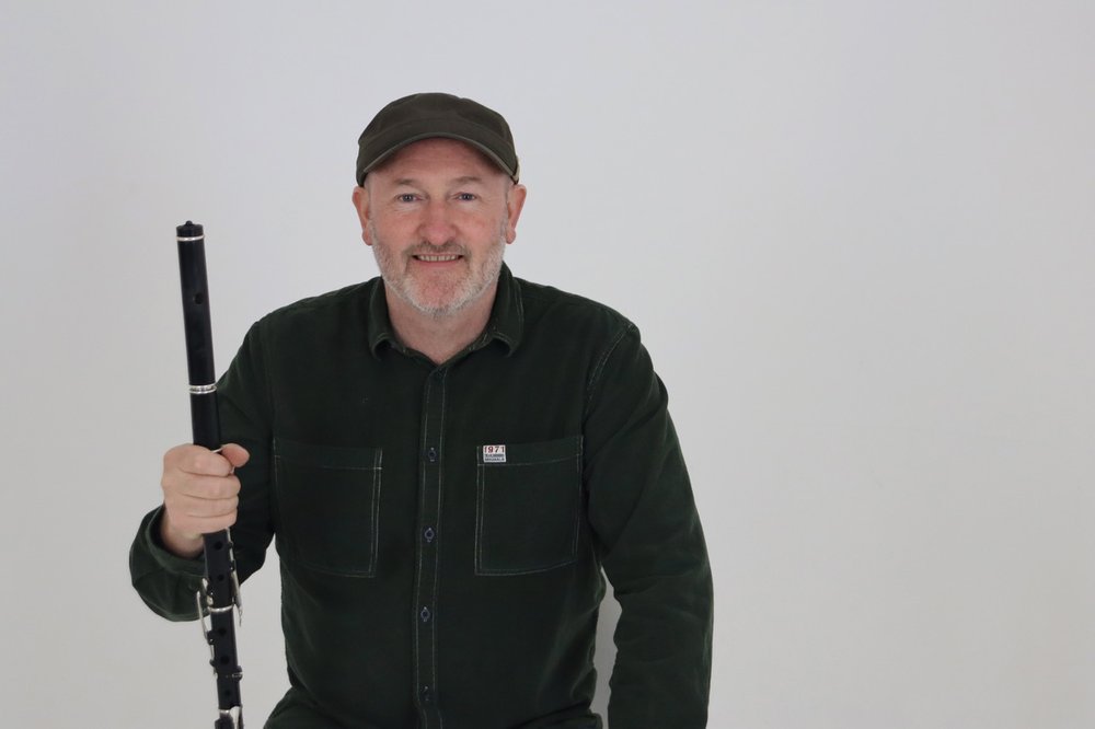 Man sitting with a flute in his hand