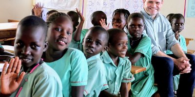 Minister Richmond with class in Uganda