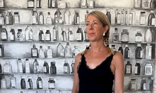 Woman standing infront of fabrics