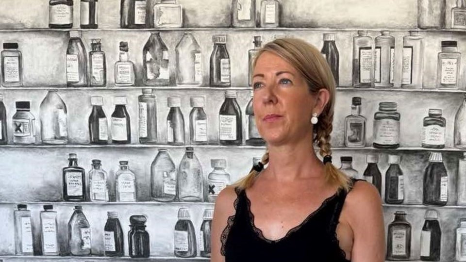 Woman standing infront of fabrics