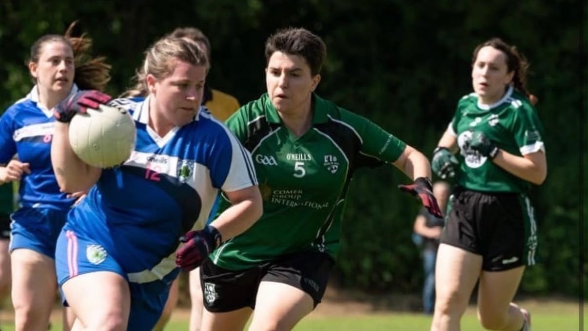 Woman dribbling the ball as other players try to tackle her
