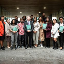 Group photo with Minister Fleming holding a report