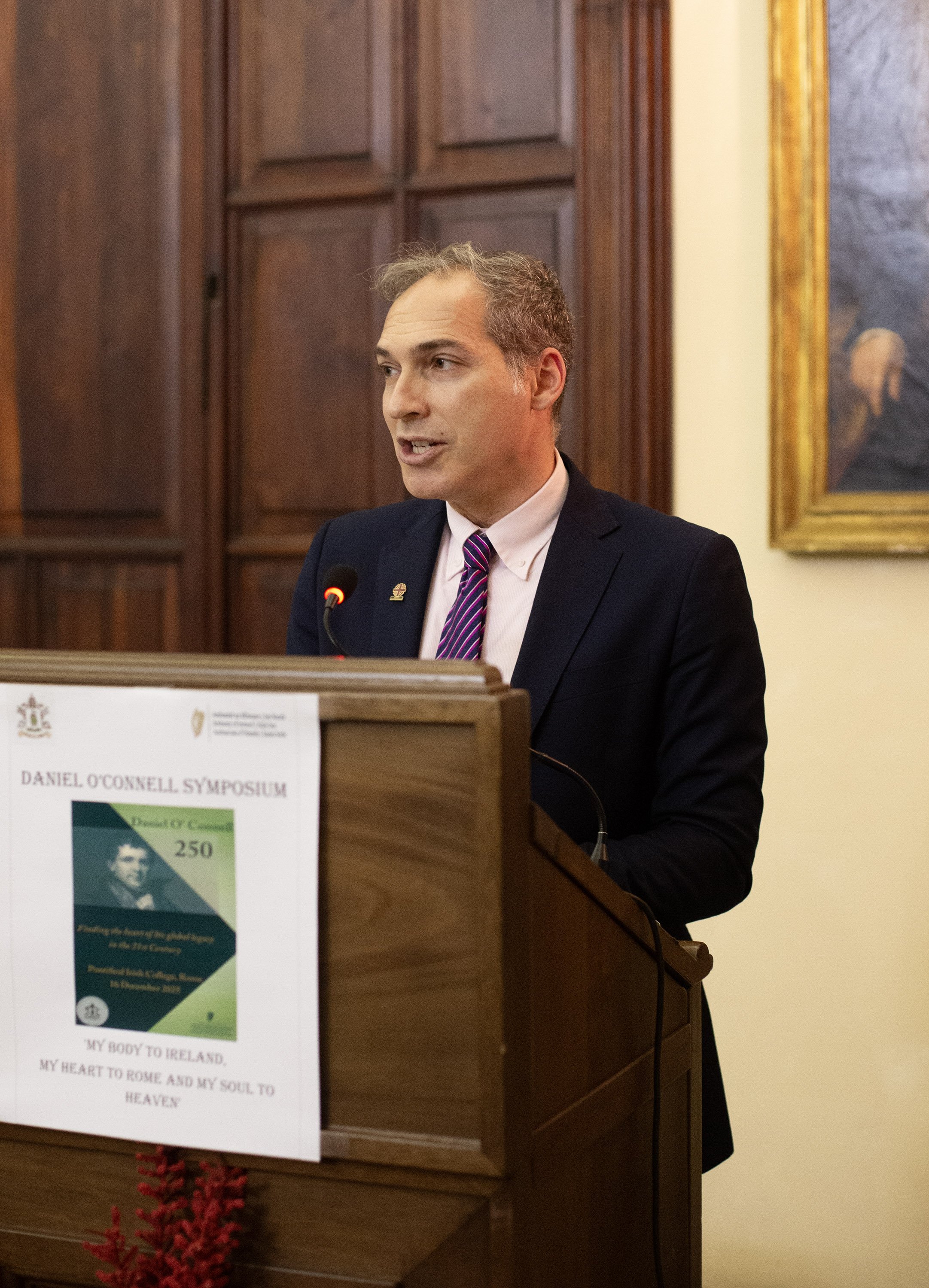 Man speaking at a plinth