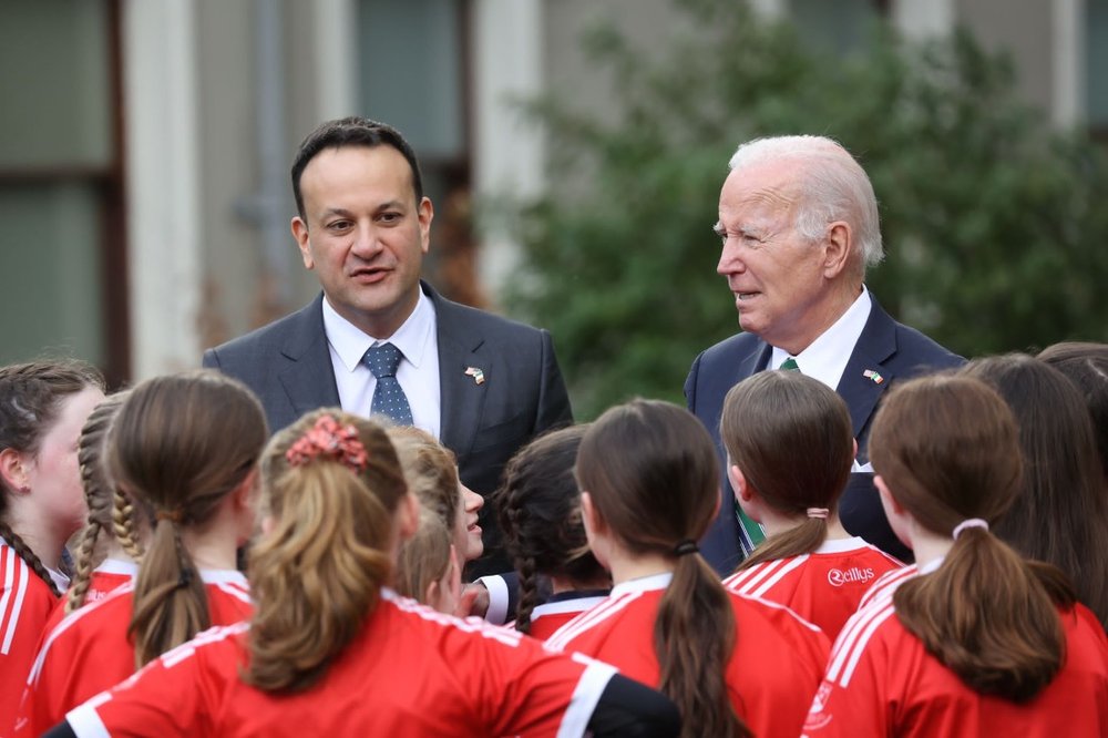 team of young camogie players talking to Taoiseach and US president