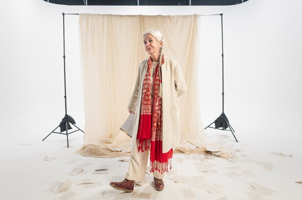 Poet, Paula Meehan in front of photography backdrop