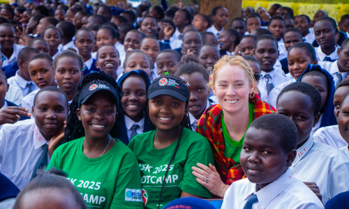Derval O'Rourke posing for a group photo with school kids