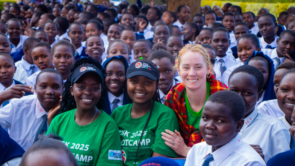 Derval O'Rourke posing for a group photo with hundreds of school kids