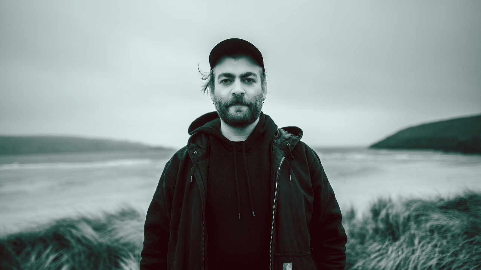 Portrait of Neil Hoare in black and white on a beach