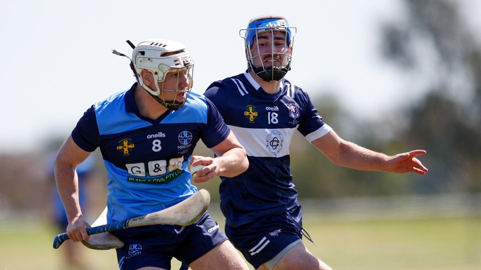 Two men playing hurling in Australia