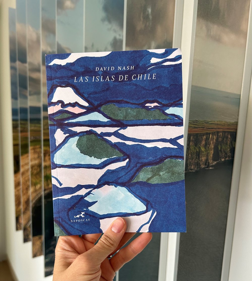 A hand holding up a copy of 'The Islands of Chile' booklet