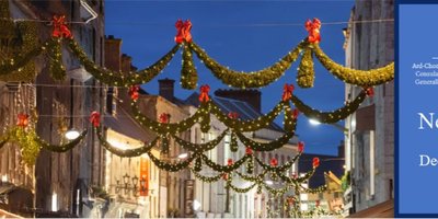 Banner containing Consulate logo and picture of Shop Street in Galway Christmas lights
