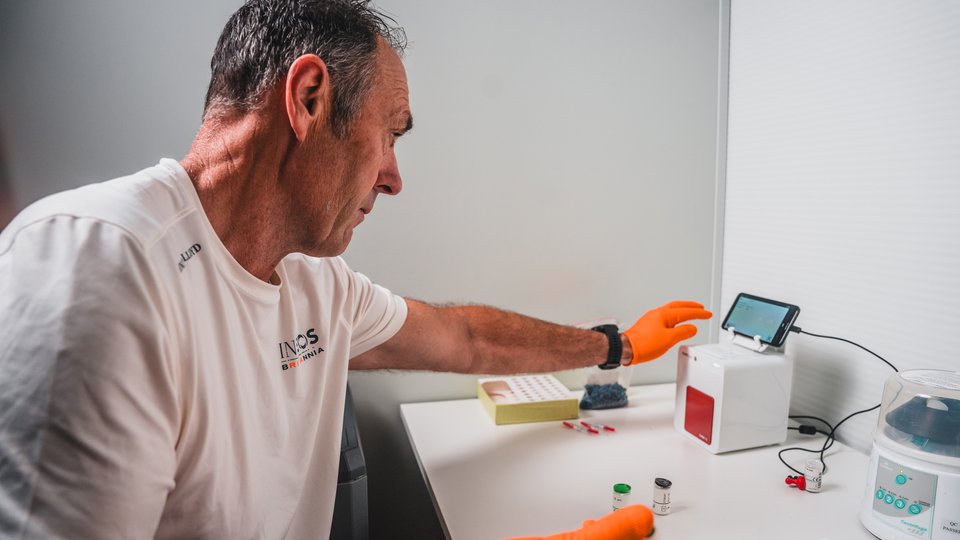 Man loading blood sample into a machine