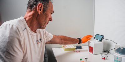 Man loading blood sample into a machine