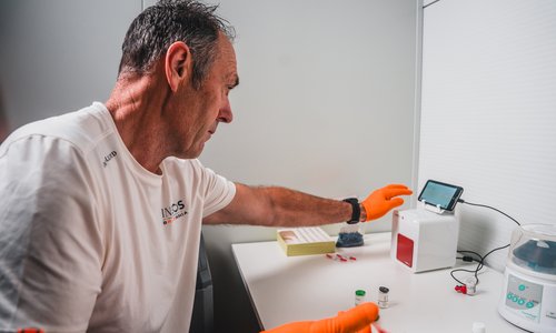 Man loading blood sample into a machine