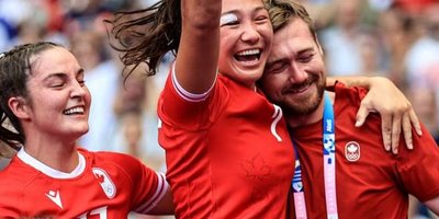 Jack Hanratty celebrating with the women's rugby team