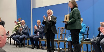 Loretta Cosgrove receiving her PDSA from President Michael D Higgins
