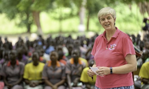 Sr Orla Treacy in front of a crowd of young women in South Sudan