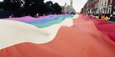 A pride flag being held up Parnell street in Dublin